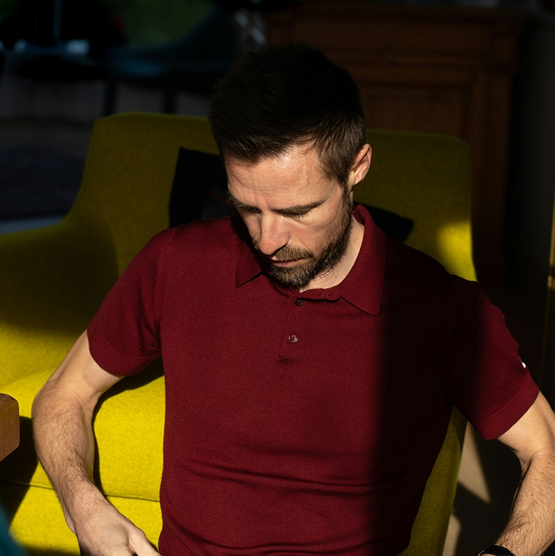 A man sitting on an armchair with his head down